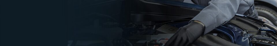A GM automotive technician performs maintenance on a vehicle.