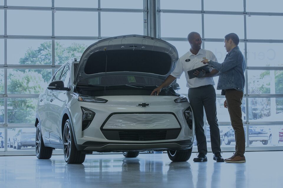 Certified Service specialist showing an EV