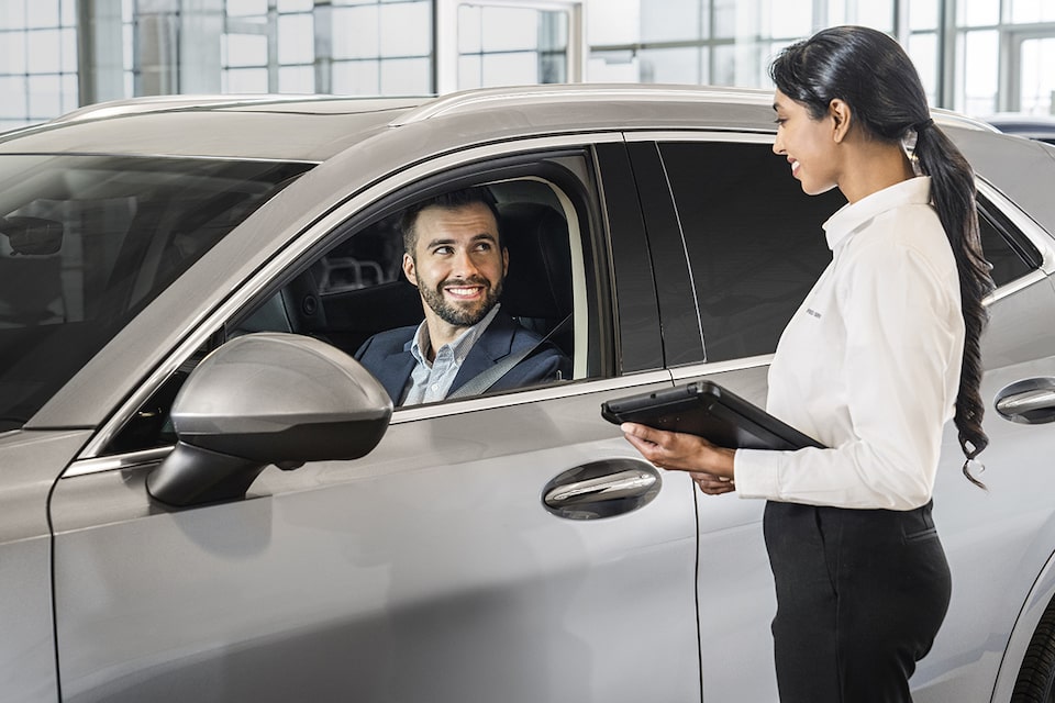 Certified Service representative discussing with an owner a comprehensive assessment of his vehicle including a Full Synthetic oil change