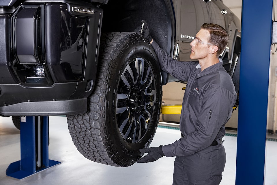 Un technicien du Service Certifié installant une roue sur un véhicule