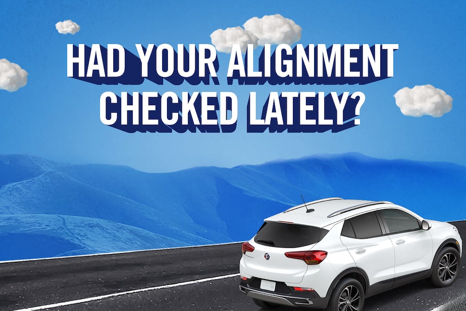 Certified Service technicians working on a vehicle's wheel alignment