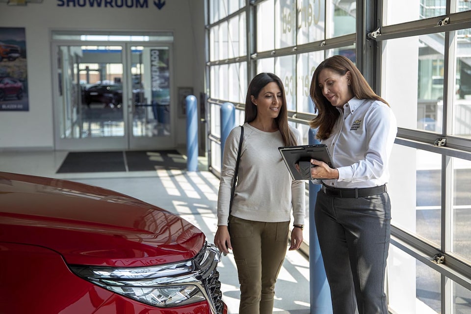 Certified Service representative discussing with an owner a comprehensive assessment of their vehicle