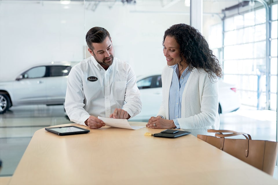Certified Service representative discussing with an owner a comprehensive assessment of her vehicle