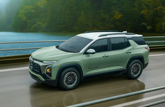 A Chevrolet Equinox covered by the GM Tire Protection Plan driving alone on a bridge.