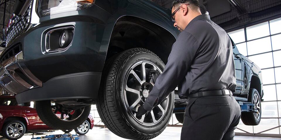A Certified Service technician completing an inspection for a wheel alignment and balance